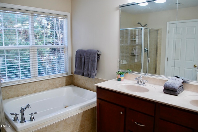 bathroom featuring visible vents, a stall shower, a sink, double vanity, and a bath