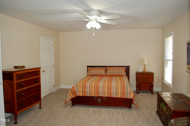 bedroom featuring baseboards, multiple windows, and carpet flooring