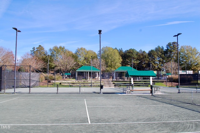 view of tennis court featuring fence