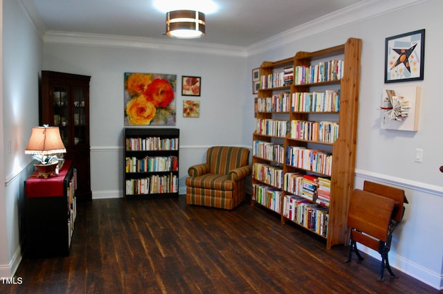 sitting room featuring crown molding, baseboards, and wood finished floors