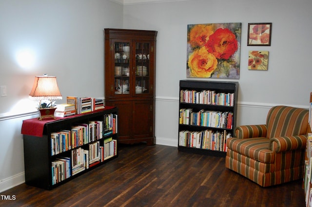 sitting room with baseboards and wood finished floors