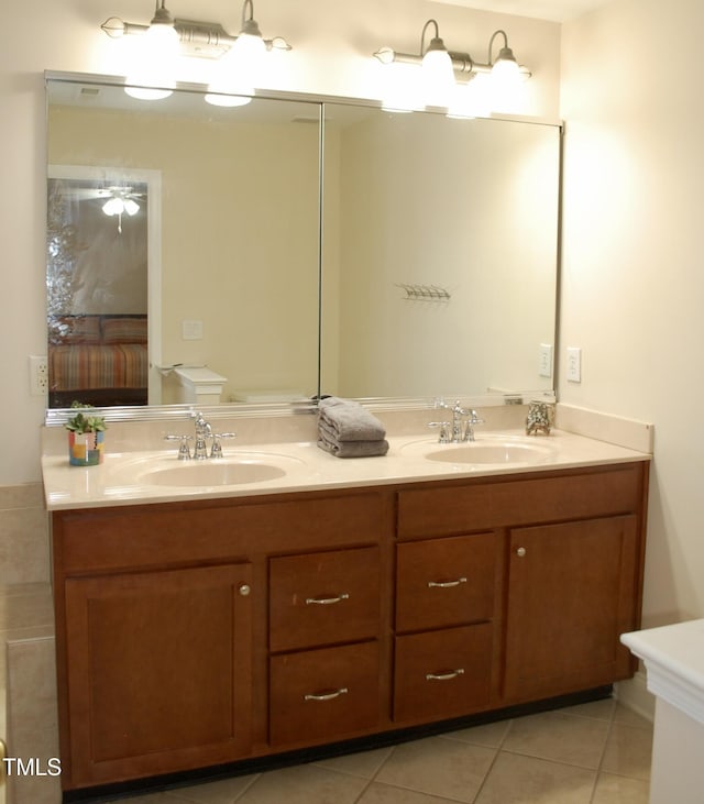 full bath featuring a sink, double vanity, and tile patterned floors