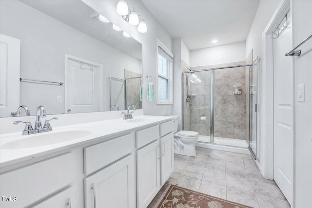 bathroom featuring tile patterned floors, vanity, toilet, and an enclosed shower