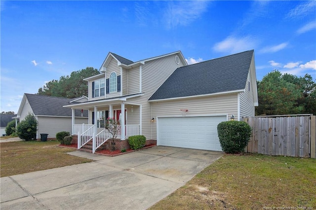 view of front of home featuring a porch, a garage, and a front lawn