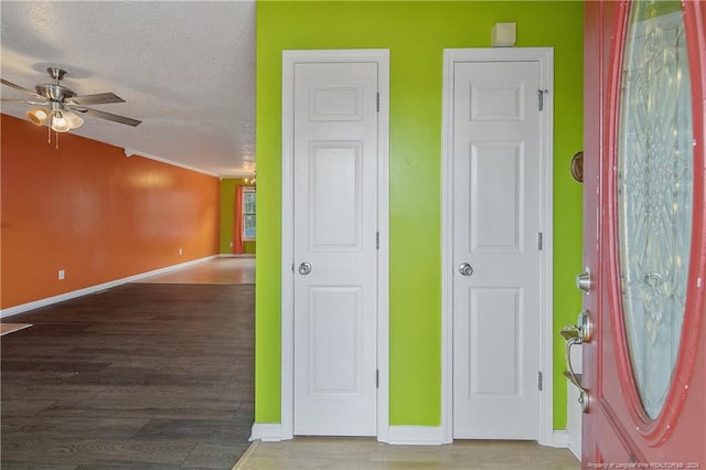 unfurnished room with lofted ceiling, ceiling fan, hardwood / wood-style floors, and a textured ceiling