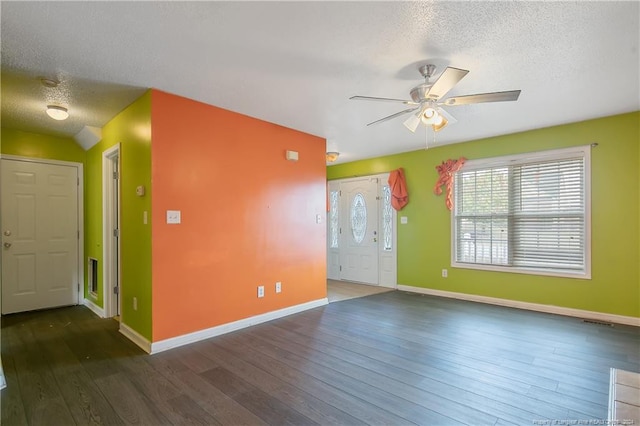 spare room featuring ceiling fan, dark hardwood / wood-style flooring, and a textured ceiling