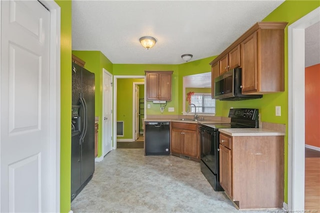 kitchen featuring light carpet, a textured ceiling, sink, and black appliances