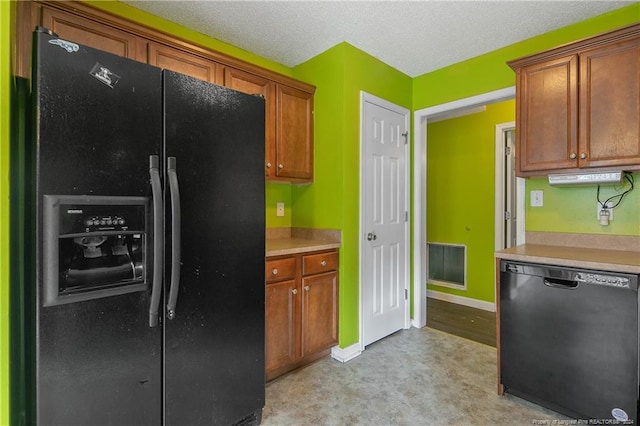 kitchen with black appliances and a textured ceiling