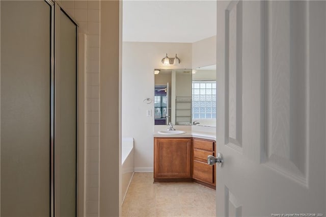 bathroom with vanity, tile patterned flooring, and plus walk in shower