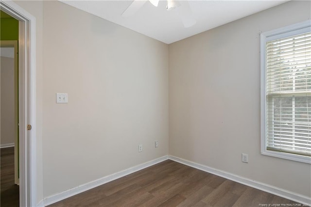 spare room featuring dark hardwood / wood-style floors and ceiling fan