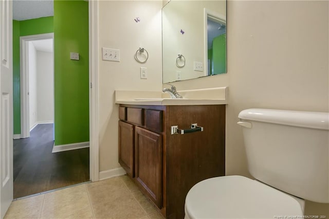 bathroom featuring hardwood / wood-style floors, vanity, and toilet