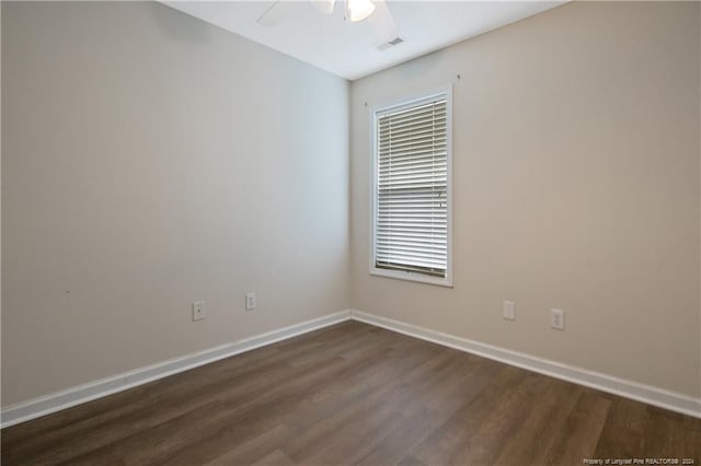 spare room featuring dark hardwood / wood-style floors and ceiling fan