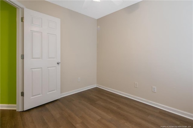 spare room with dark wood-type flooring