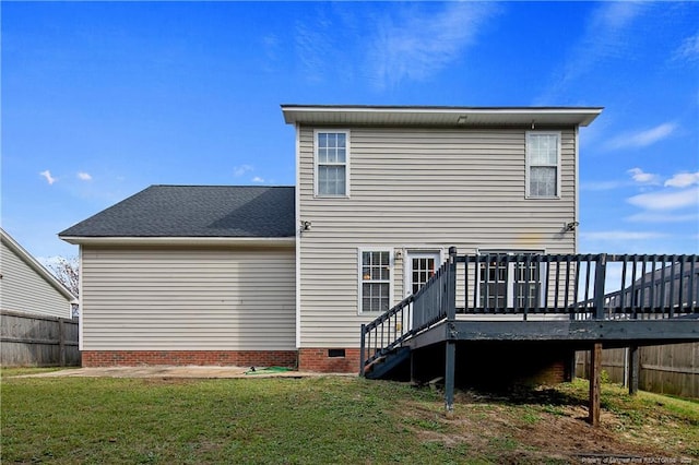 rear view of house with a yard and a wooden deck