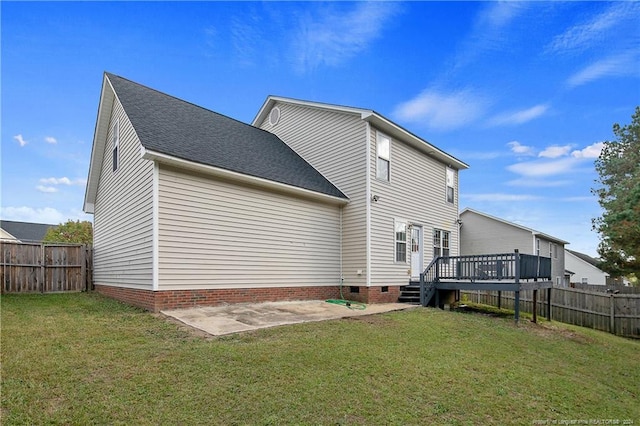 back of house featuring a yard, a patio area, and a wooden deck