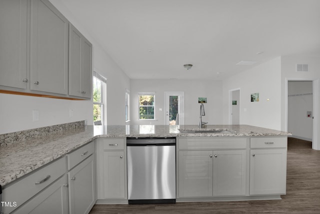 kitchen featuring kitchen peninsula, sink, stainless steel dishwasher, and dark hardwood / wood-style floors