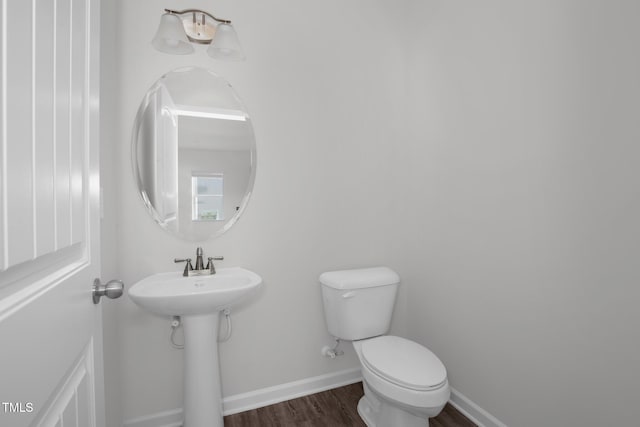 bathroom featuring hardwood / wood-style floors, toilet, and sink