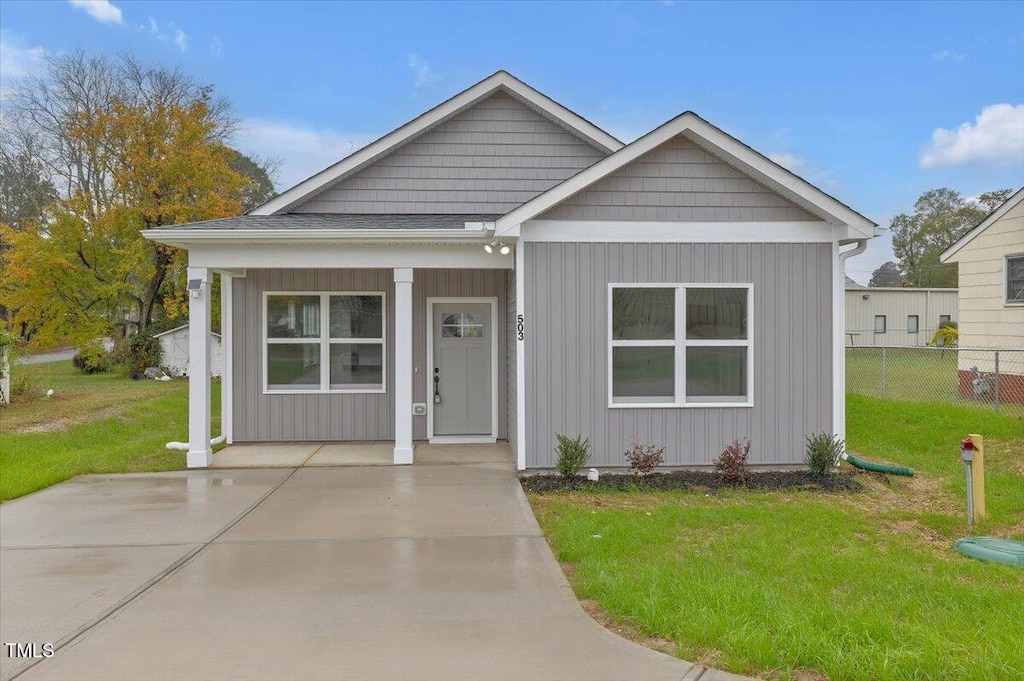 view of front of home with covered porch and a front yard