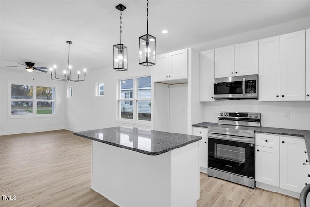 kitchen with white cabinetry, ceiling fan, pendant lighting, and appliances with stainless steel finishes