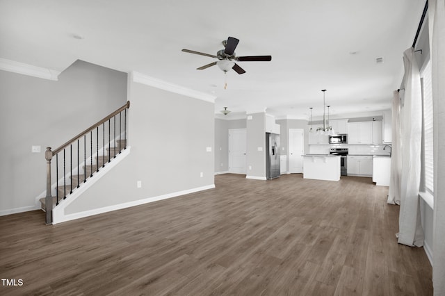 unfurnished living room with dark hardwood / wood-style floors, ceiling fan, and ornamental molding