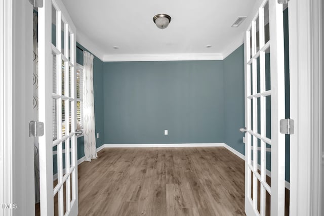 unfurnished room with light hardwood / wood-style floors and ornamental molding