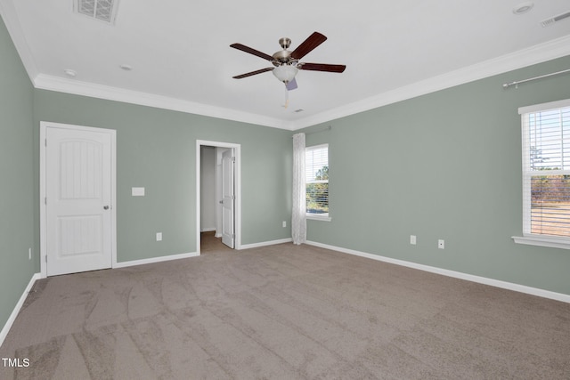 unfurnished bedroom with light colored carpet, ceiling fan, and crown molding