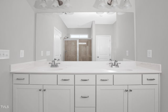 bathroom featuring vanity and a shower with shower door