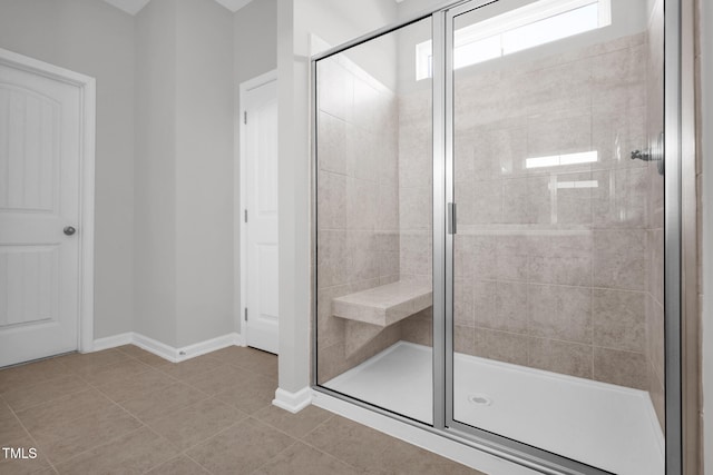 bathroom featuring tile patterned floors and a shower with door