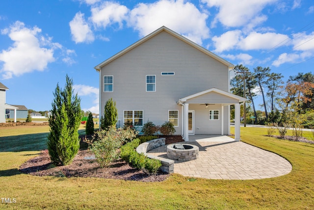 rear view of house featuring a lawn, a patio area, ceiling fan, and a fire pit