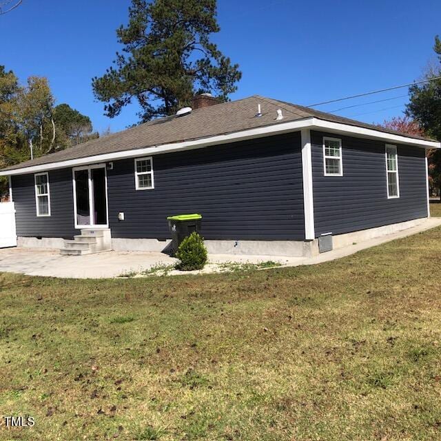 back of house with a yard and a patio area