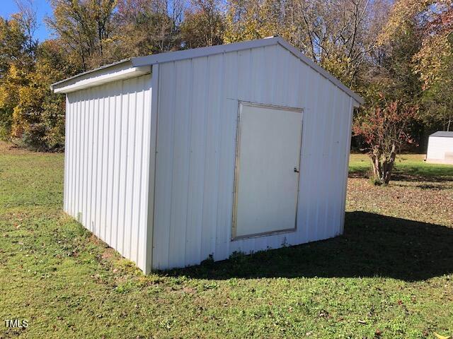 view of outbuilding with a yard