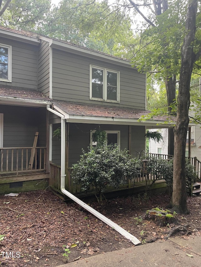 view of side of property with covered porch