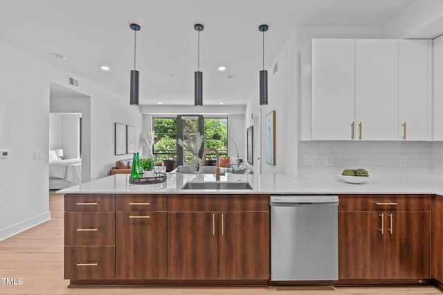 kitchen with white cabinets, dishwasher, pendant lighting, and sink