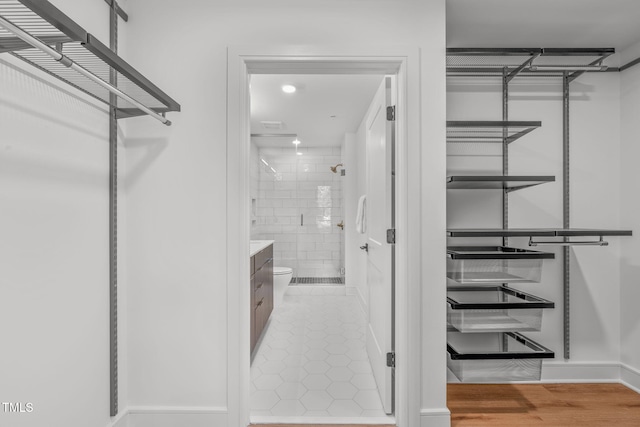 spacious closet with hardwood / wood-style floors