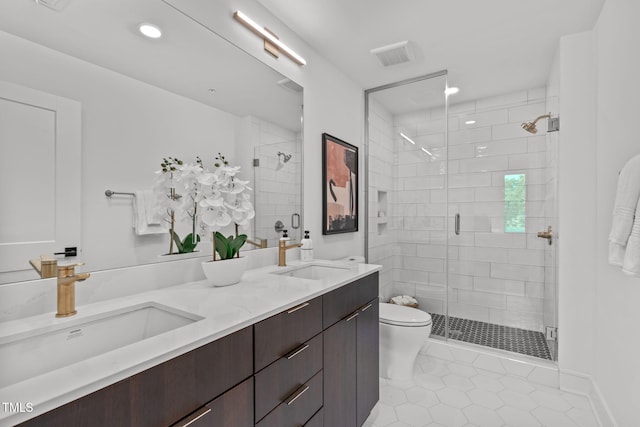 bathroom featuring tile patterned floors, a shower with door, vanity, and toilet