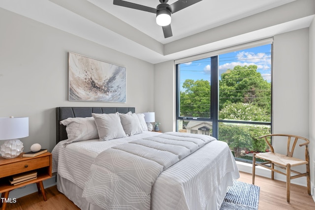 bedroom with light hardwood / wood-style floors and ceiling fan