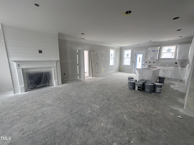 unfurnished living room featuring a wealth of natural light