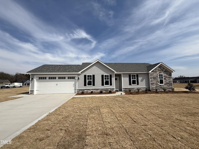 ranch-style home with roof with shingles, concrete driveway, a front lawn, stone siding, and a garage