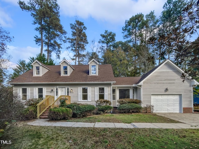 cape cod-style house featuring a front lawn and a garage