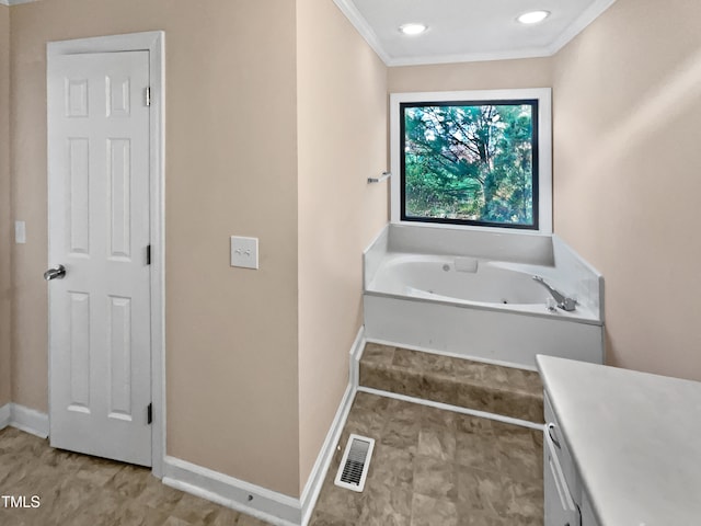 bathroom with a tub, vanity, and ornamental molding