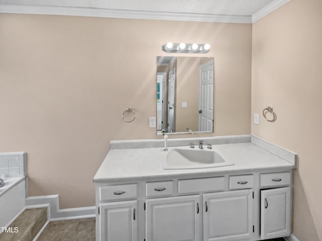 bathroom featuring a textured ceiling, vanity, crown molding, and tile patterned floors