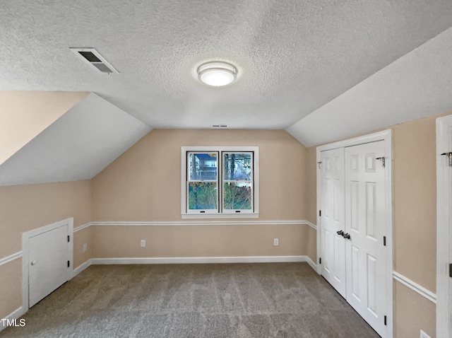 bonus room with carpet flooring, a textured ceiling, and lofted ceiling