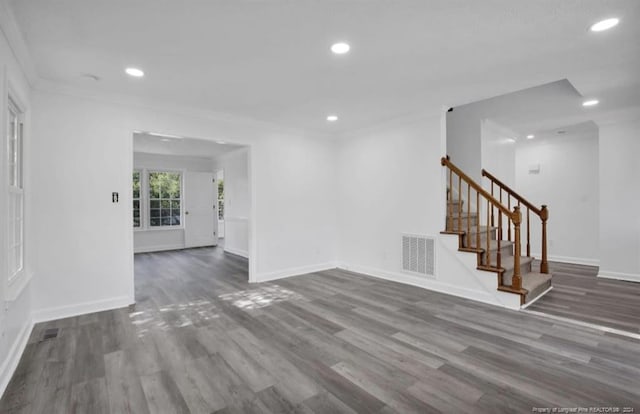 spare room with dark hardwood / wood-style flooring and crown molding