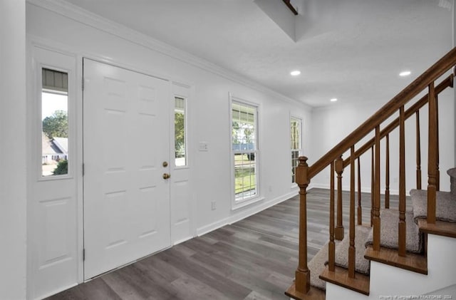 foyer with dark hardwood / wood-style floors and ornamental molding