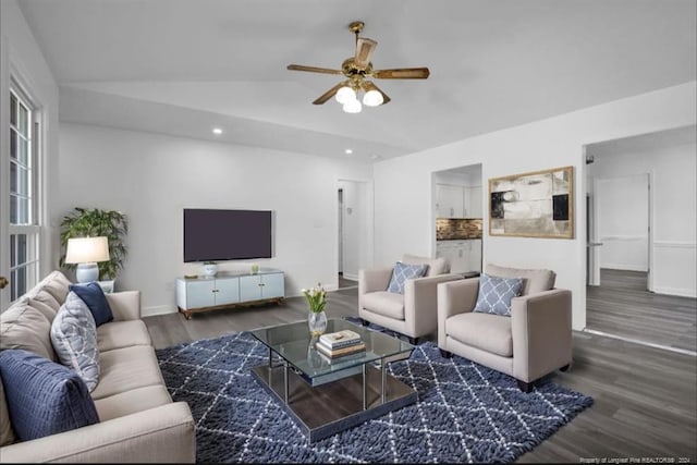 living room with dark hardwood / wood-style floors, ceiling fan, and lofted ceiling