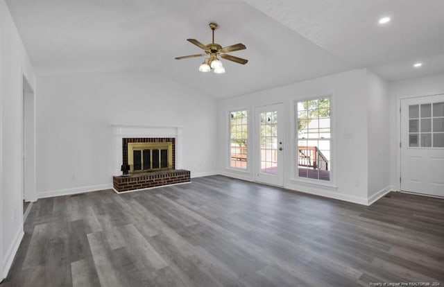 unfurnished living room with ceiling fan, dark wood-type flooring, lofted ceiling, and a brick fireplace