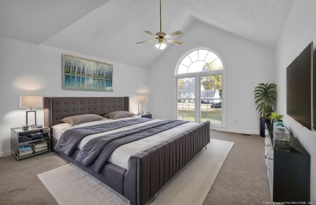 carpeted bedroom with ceiling fan and high vaulted ceiling