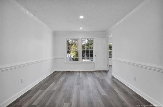 spare room with dark wood-type flooring and ornamental molding