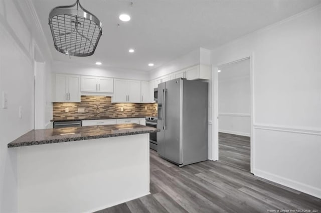 kitchen with crown molding, hardwood / wood-style floors, white cabinets, and appliances with stainless steel finishes