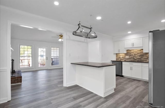 kitchen with white cabinetry, ceiling fan, stainless steel appliances, and wood-type flooring